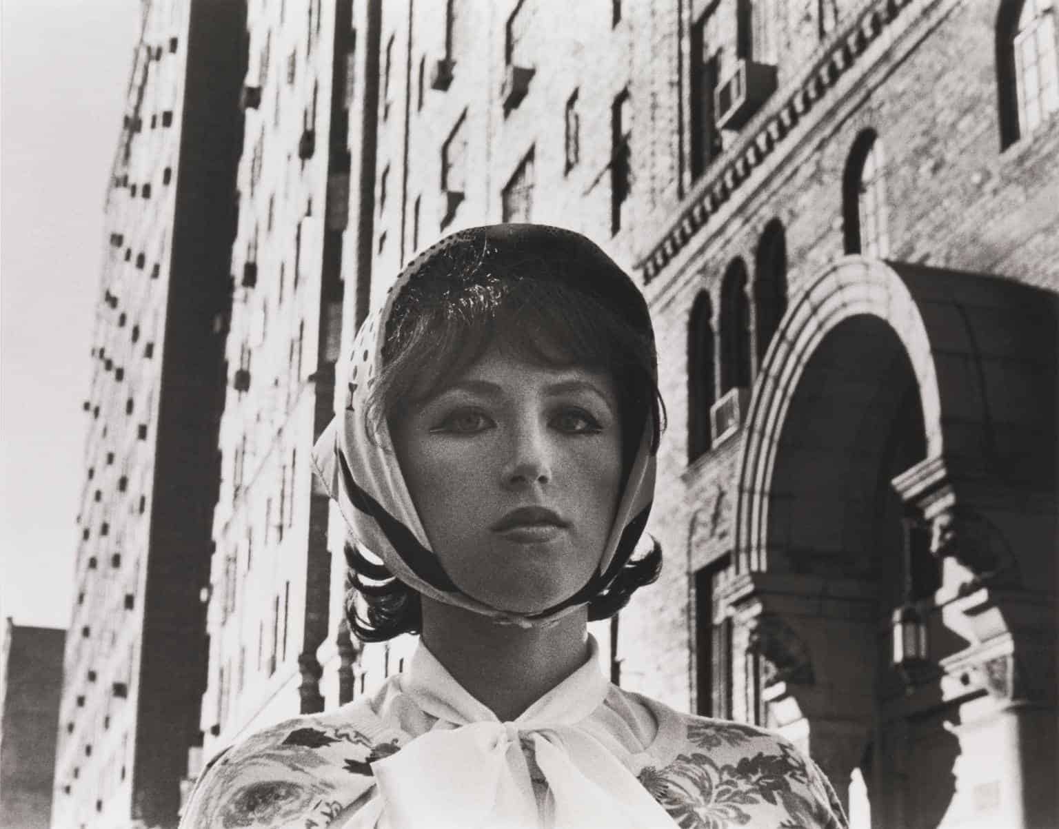 A black and white portrait of Cindy Sherman from her iconic "Untitled Film Stills" series, showcasing her signature character portrayal.