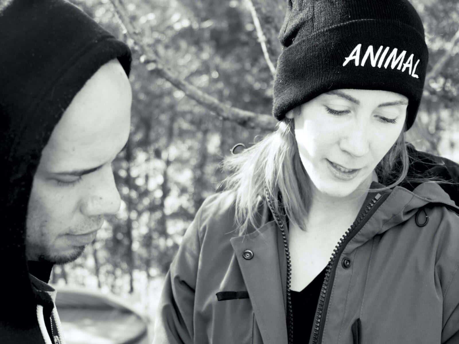 Black and white photo of two people engaged in a conversation.