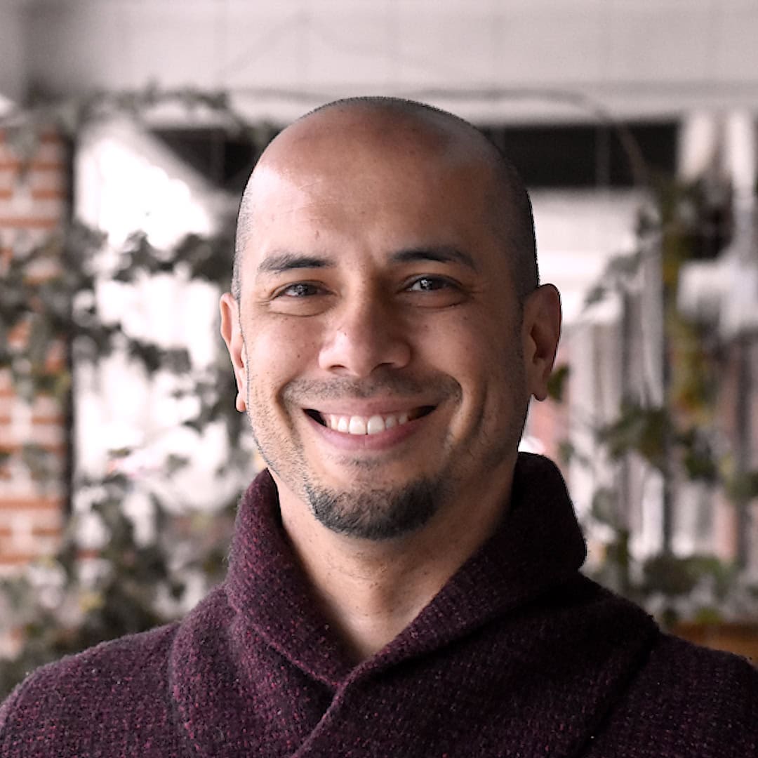 Smiling team member with a friendly expression, representing the compassionate and professional staf.
